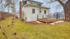 A single-story house with a front deck, a brick chimney, and a small porch with outdoor seating. - Families w/ Pets! Home 8 Mi to Dtwn Minneapolis (Golden Valley)