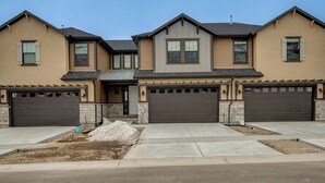 A modern two-story house with a garage, a front porch, and a landscaped front yard. - Hot Tub: Heber City Home 15 Mi to Park City! (Heber City)