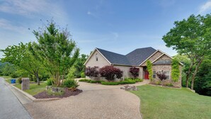 A two-story house with a stone facade, a grey roof, and a red door. - 4 Mi to Branson Landing: Huge Home w/ Game Room! (Branson)