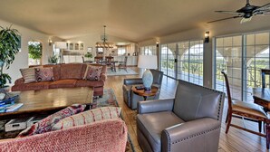 A spacious living room with a large sectional sofa, a leather armchair, and a coffee table. There is a dining area with a table and chairs, and a kitchen in the background. - Working Vineyard & Private Pool: Villa in Plymouth (Plymouth)