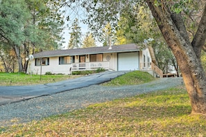 A single-story house with a front porch, a garage, and a driveway leading to the entrance.