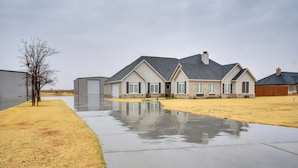 A residential house with a large driveway and a small yard. - Relaxing Lubbock Studio ~ 6 Mi to Texas Tech (Lubbock)