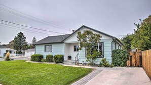 A single-story house with a light blue exterior, a front porch, and a well-maintained lawn.