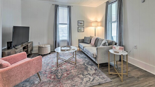 A living room with a sofa, a coffee table, a TV, and a lamp.