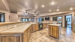 A spacious kitchen with a large island, wooden cabinets, and a built-in oven. - Hot Tub & Mtn Views! 'casa Ruidoso' Cabin (Alto)
