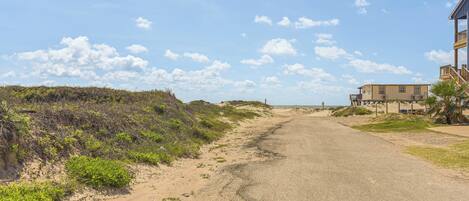 A coastal road with a building on the right.