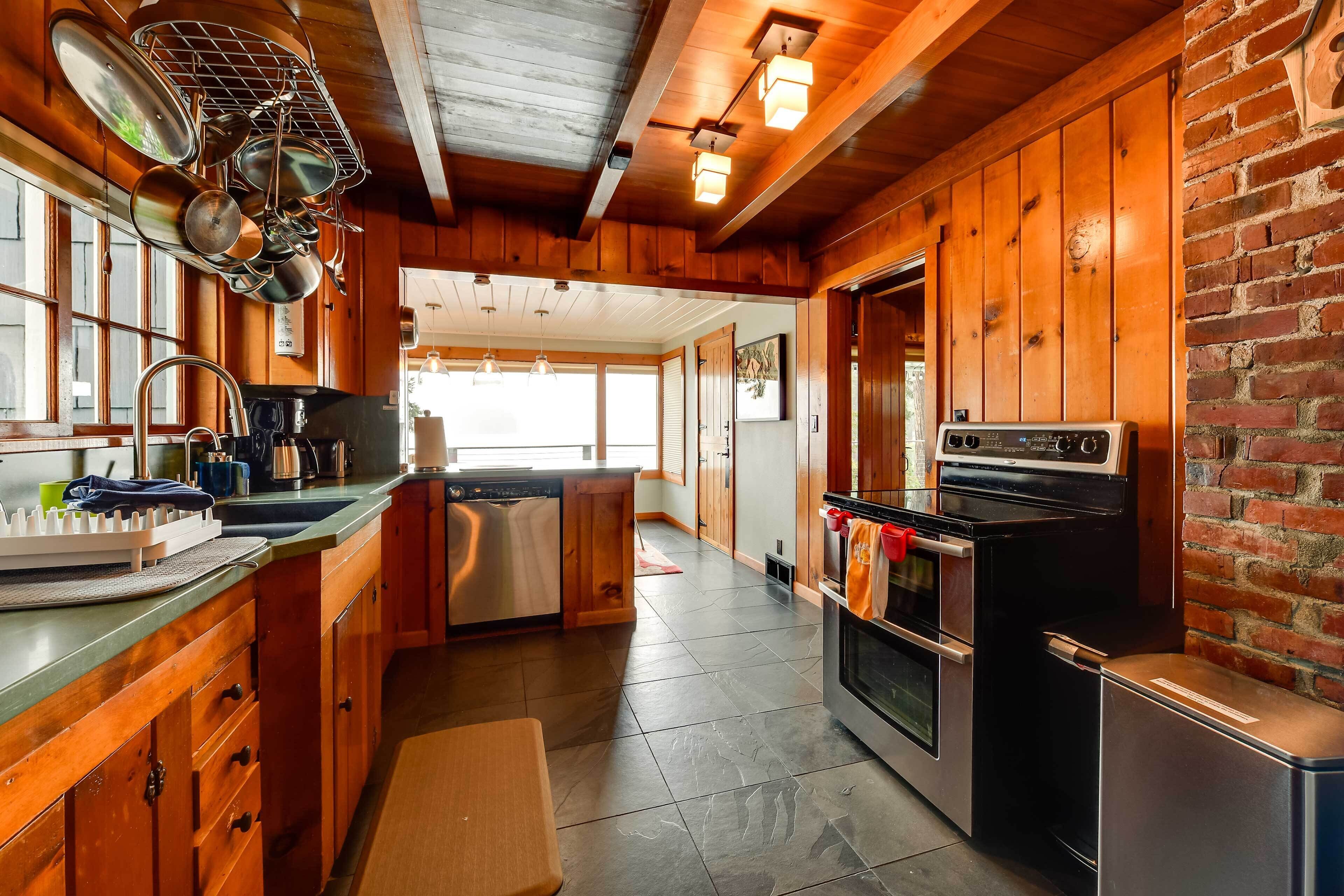 A kitchen with wooden cabinets, a stainless steel refrigerator, and a stove.