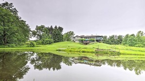 A house with a large yard, a pond, and surrounding greenery. - 'mimis Place' ~ Ohio Countryside Duplex w/ Deck (Dalton)