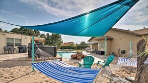 A backyard with a pool, outdoor seating, and a hammock. - Albuquerque Studio With Shared Pool & Fire Pit! (Albuquerque)