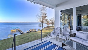 A covered outdoor area with a view of a lake, a dock, and a grassy area. - Beautiful Waterfront Getaway w/ Dock! (Abbeville)