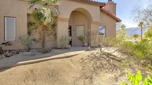 A stucco building with a tiled roof, an arched entrance, and a palm tree in the foreground. - Borrego Springs Condo w/ Private Hot Tub & Views! (Borrego Springs)