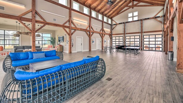 A spacious indoor area with high ceilings, wooden beams, and large windows. - Beaufort Townhome w/ Game Room: 8 Mi to Beaches! (Beaufort)