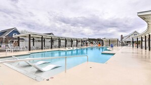 A swimming pool with a covered area, lounge chairs, and a poolside deck. - Beaufort Townhome w/ Game Room: 8 Mi to Beaches! (Beaufort)