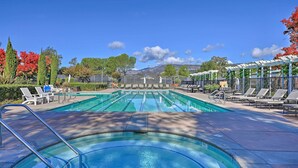 A swimming pool with multiple lanes, surrounded by lounge chairs and a pergola. - Bright & Airy Napa Condo W/patio on Golf Course! (Napa)