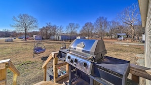 A backyard with a barbecue grill, a swing chair, and a wooden deck. - Close to Marinas: Bernice Home w/ Large Yard (Afton)