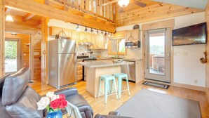A spacious kitchen with wooden beams, a central island, and modern appliances. - Sawyers Cabin w/ Hot Tub in Blue Ridge Mtns! (Fletcher)