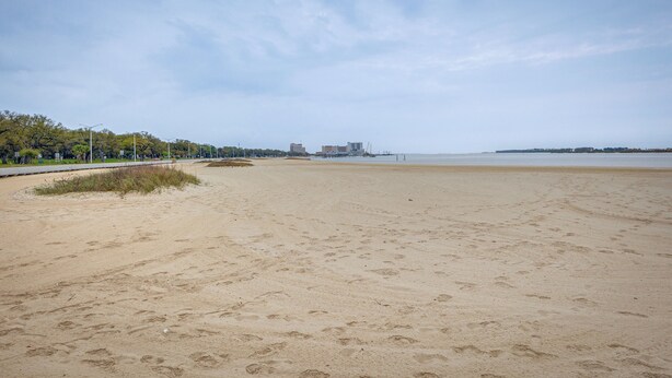 A wide sandy beach with a clear sky. - Charming Biloxi Vacation Rental Near Beach! (Biloxi)