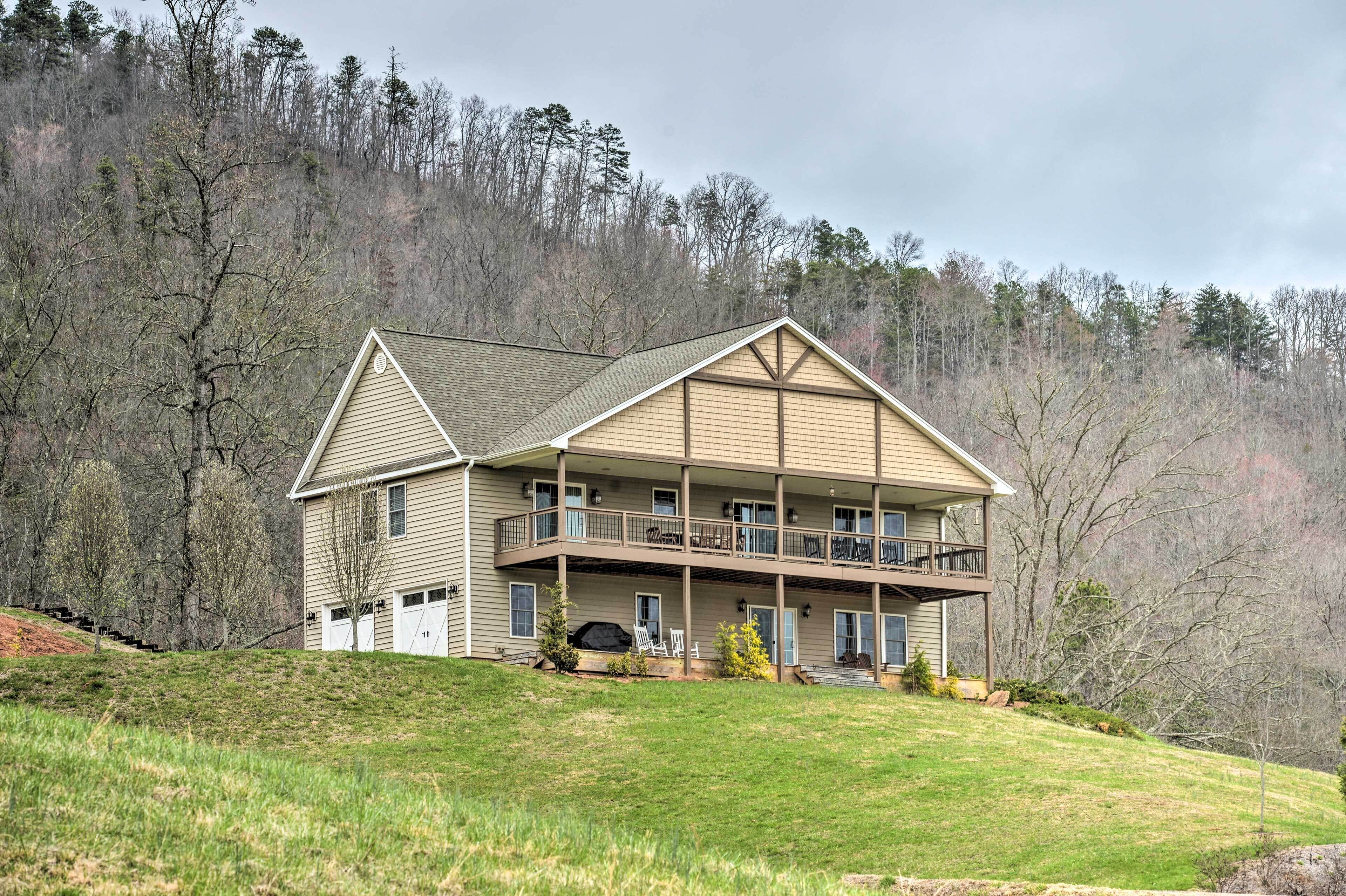 A two-story house with a balcony on the second floor, a covered front porch, and a garage.