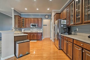 A kitchen with wooden cabinets, stainless steel appliances, and a built-in dishwasher. - Great for Groups: Bayside Resort Home w/ Patio (Selbyville)