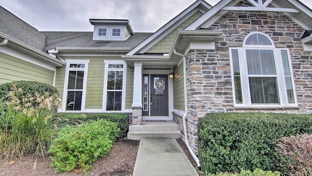 A two-story house with a stone facade, a front porch, and a well-maintained garden. - Great for Groups: Bayside Resort Home w/ Patio (Selbyville)