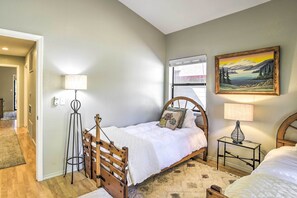 A bedroom with a bed, bedside table, lamp, and a painting on the wall. - Charming Chester Home w/ Furnished Porch! (Chester)