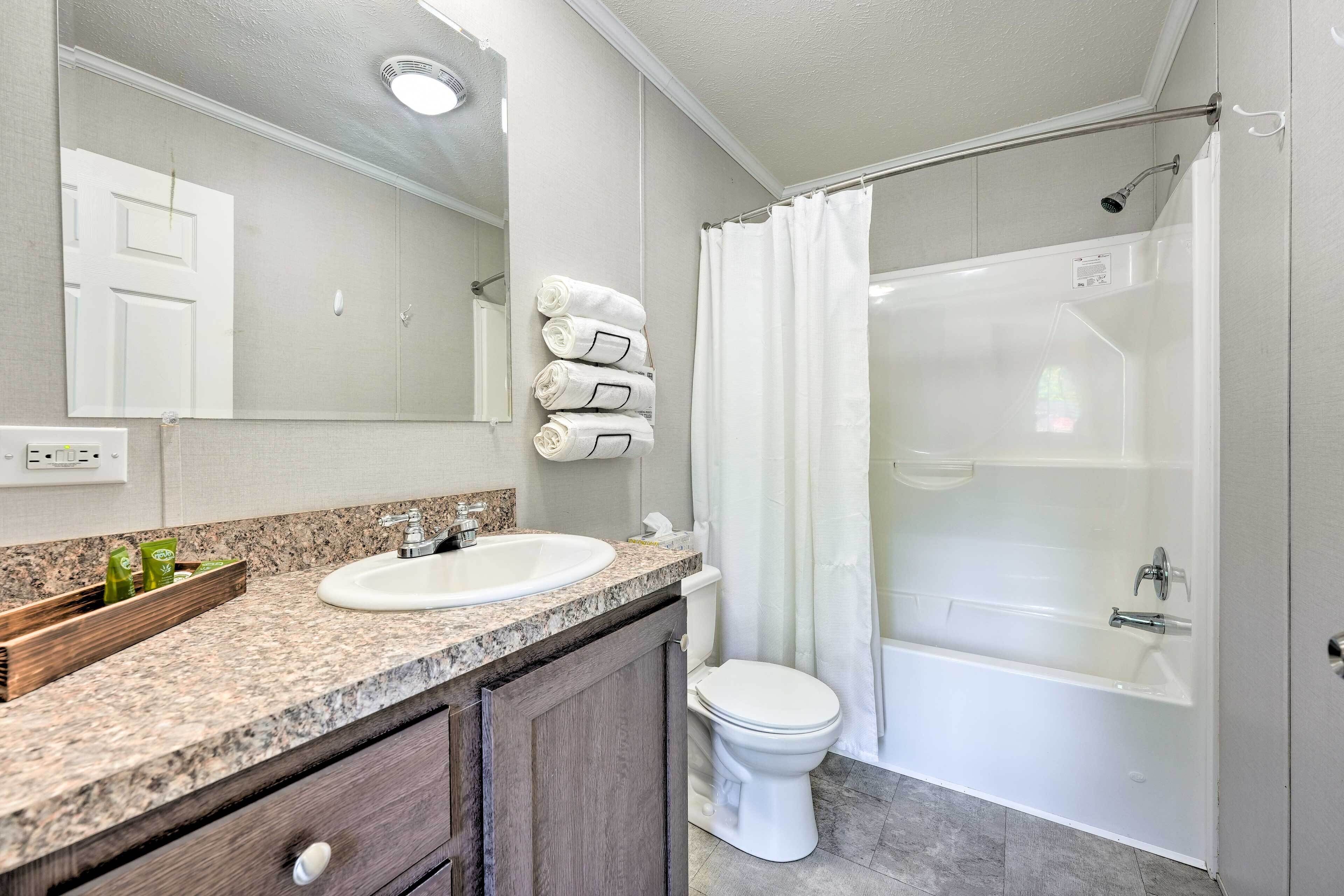 A bathroom with a sink, toilet, and shower.