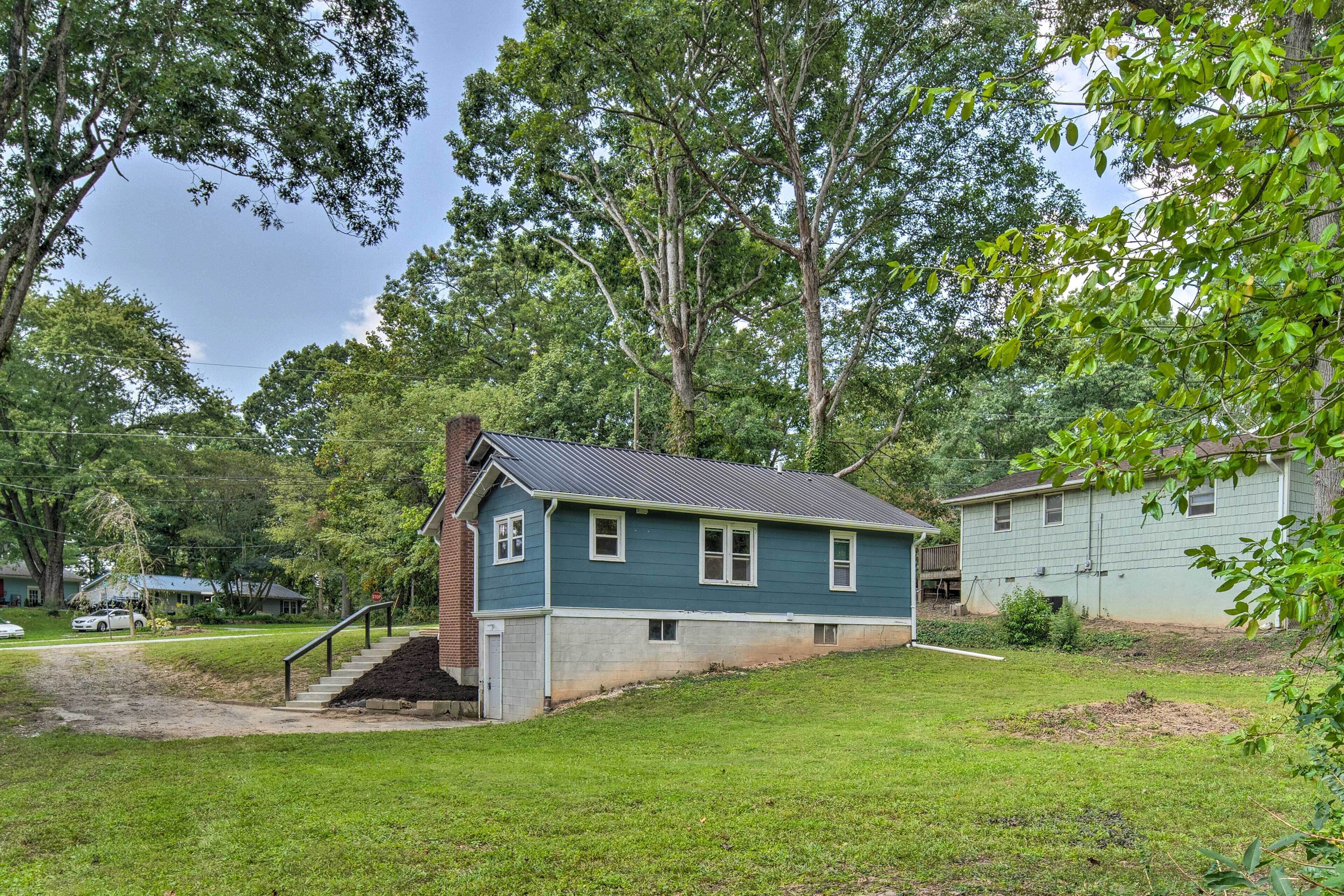 A single-story house with a front porch, a small front yard, and a driveway.