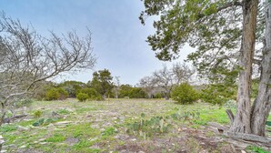 A natural landscape with sparse vegetation, rocky ground, and trees. - Cozy Kerrville Guest Cottage Near Guadalupe River! (Kerrville)
