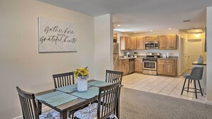 A modern kitchen with wooden cabinets, a microwave, and a built-in oven. - Glen Cove Home: Walk to Boardwalk + Dining! (Glen Cove)
