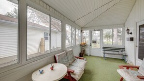 A covered porch with a bench, a table, and a hanging plant. - Historic Alexandria Home w/ Private Yard! (Alexandria)