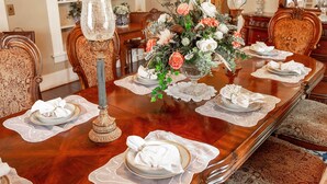 A formal dining table set with plates, napkins, and a centerpiece. - Historic Huntington Home w/ Pond & Flower Gardens! (Huntington)
