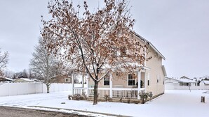 A two-story house with a porch and a snow-covered yard. - Meadow Retreat' Near Parks & USU (Logan)