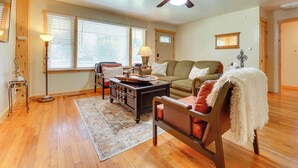 A living room with a sofa, armchair, coffee table, and a ceiling fan. - Fruita Vacation Rental: Walk to Downtown! (Fruita)