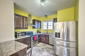 A kitchen with granite countertops, stainless steel appliances, and dark wooden cabinets. - Harrisonburg Retreat w/ Hot Tub ~ 2 Mi to JMU (Harrisonburg)