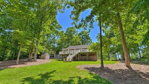 A house with a covered porch and a small shed in a wooded area. - Lake Norman Retreat w/ Dock ~ 1 Mi to Marina! (Mooresville)