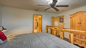 A bedroom with a bed, a ceiling fan, a wooden dresser, and a door leading to a bathroom. - Emory Escape w/ Pond Access < 13 Mi to Lake! (Emory)