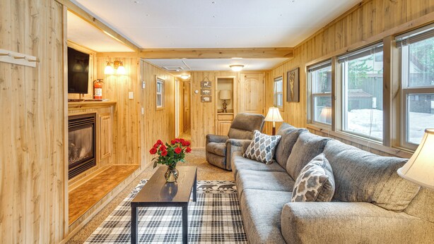 A cozy living room with a fireplace, a sofa, a coffee table, and a lamp. - Cozy Island Park Getaway By ATV Trails & Reservoir (Island Park)