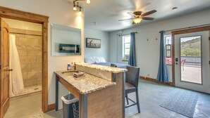A modern bathroom with a shower, a sink, and a toilet. - Lava Hot Springs Studio w/ Deck: Walk to Hot Pools (Lava Hot Springs)