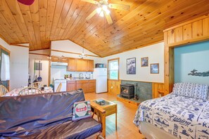 A cozy cabin interior with a dining area, kitchen, and a fireplace. - Cabin w/ Hot Tub - Near Nantahala Outdoor Center! (Bryson City)