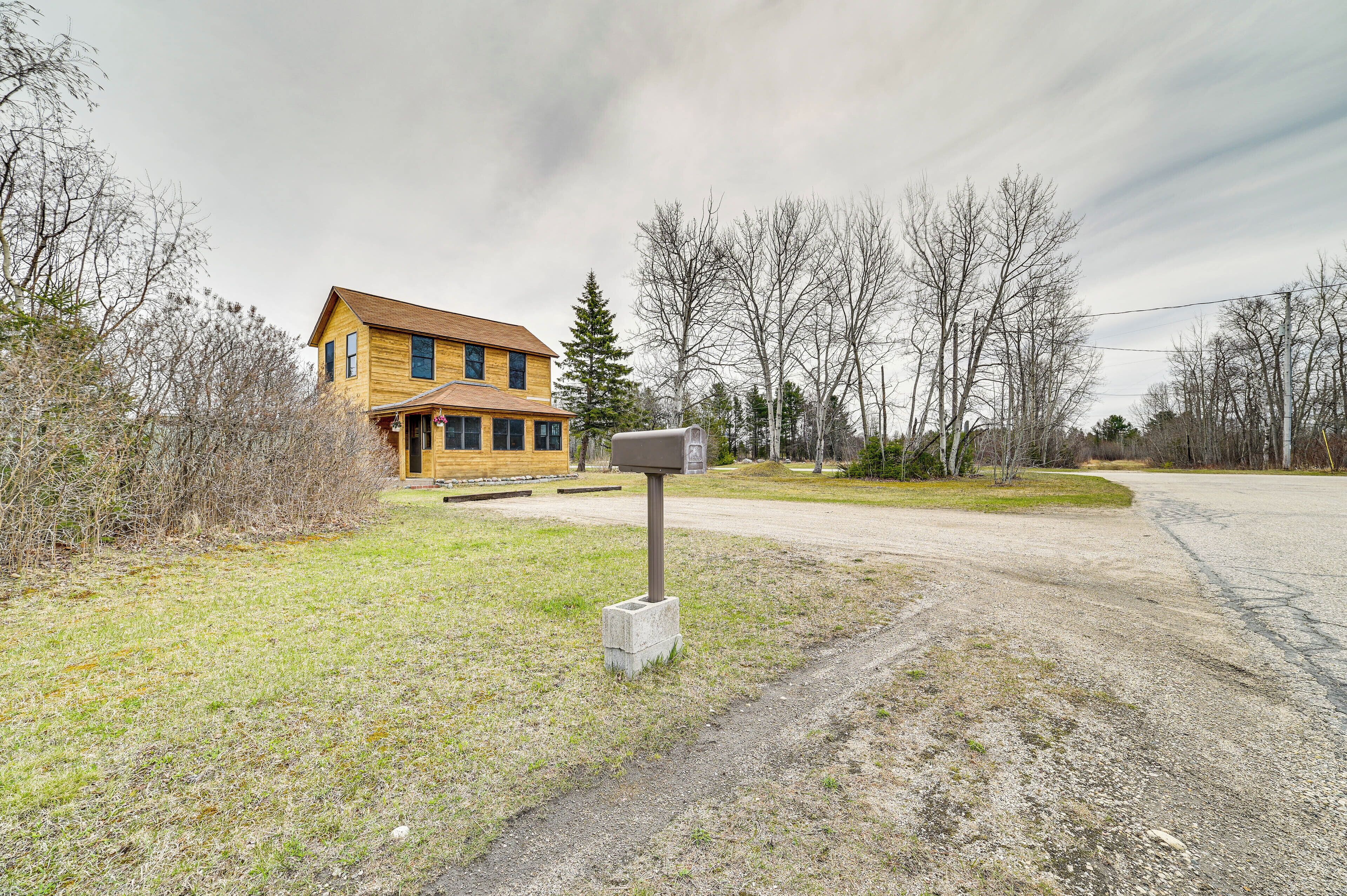 A two-story wooden house with a mailbox in front.