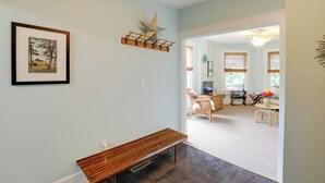 A living room with a wooden bench, a star decoration, and a framed picture on the wall.