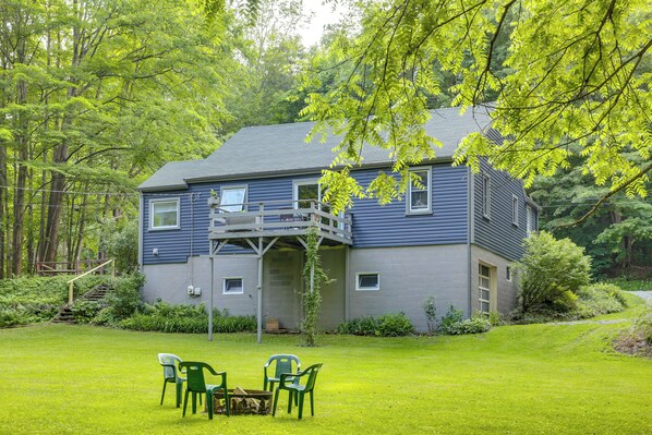 A two-story house with a balcony, surrounded by a well-maintained lawn and trees. - Meadville Home: Private Yard & Fishing Nearby (Meadville)