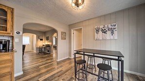A kitchen with a wooden countertop, two stools, and a hanging light fixture. - Meadville Home: Private Yard & Fishing Nearby (Meadville)