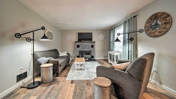A living room with a fireplace, two armchairs, a sofa, a coffee table, and a floor lamp. - Meadville Home: Private Yard & Fishing Nearby (Meadville)