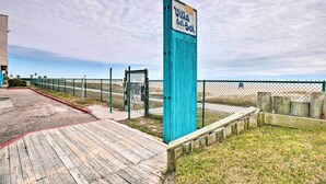 A wooden boardwalk leading to a beach area with a sign reading "Villa del Sol". - Oceanfront Corpus Christi Condo w/ Pool! (Corpus Christi)