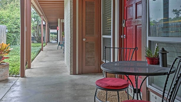 A covered outdoor area with a table and chairs, a door, and a window. - 5 Mi to Dtwn: Austin Gem w/ Pool, Pets Welcome (Austin)