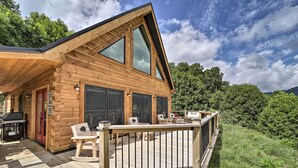 A wooden cabin with a deck, large windows, and a grill area. - Luxe Log Cabin w/ Modern Finishes & Mtn Views (Maggie Valley)
