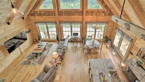 A spacious wooden cabin with a large living area, dining space, and a kitchen. - Luxe Log Cabin w/ Modern Finishes & Mtn Views (Maggie Valley)