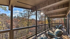 A covered outdoor seating area with a view of autumn foliage. - Hike, Bike & Unwind: Bella Vista Family Home! (Bella Vista)