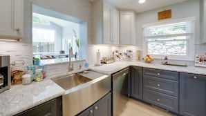 A modern kitchen with white cabinetry, stainless steel appliances, and a marble countertop. - Remote Smoky Mtn Escape w/ Views & Trail Access! (Franklin)